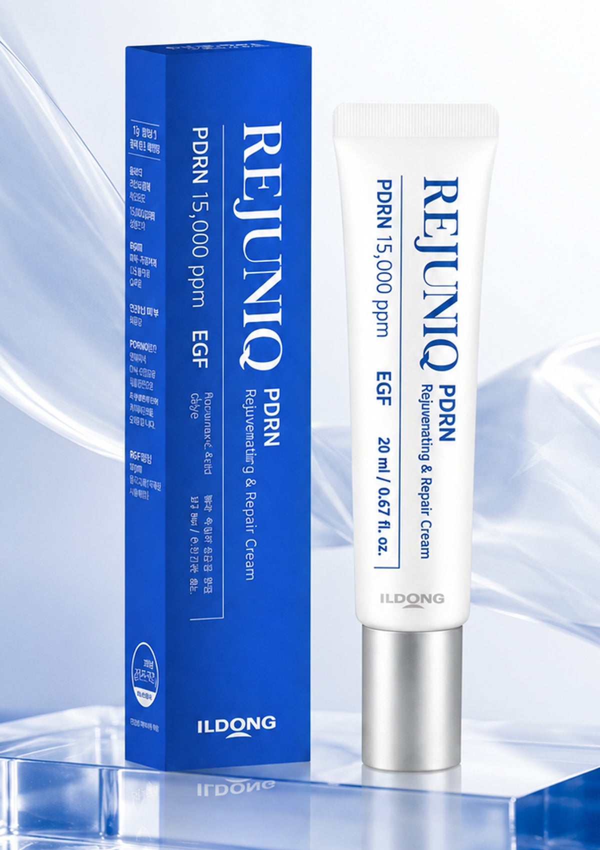 A white tube and blue box of Ildong Rejunio PDRN Regenerating & Repair Cream, displayed on a reflective blue surface against a light blue abstract background.